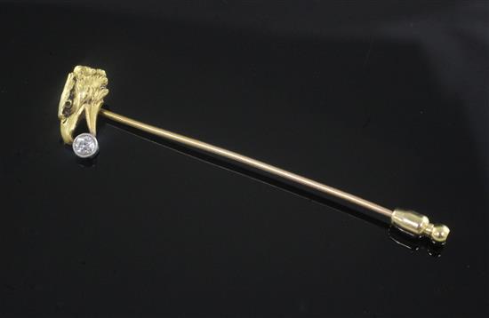 An early 20th century French 18ct gold and solitaire diamond set tie pin, modelled as an eagles head holding the stone, 73mm.